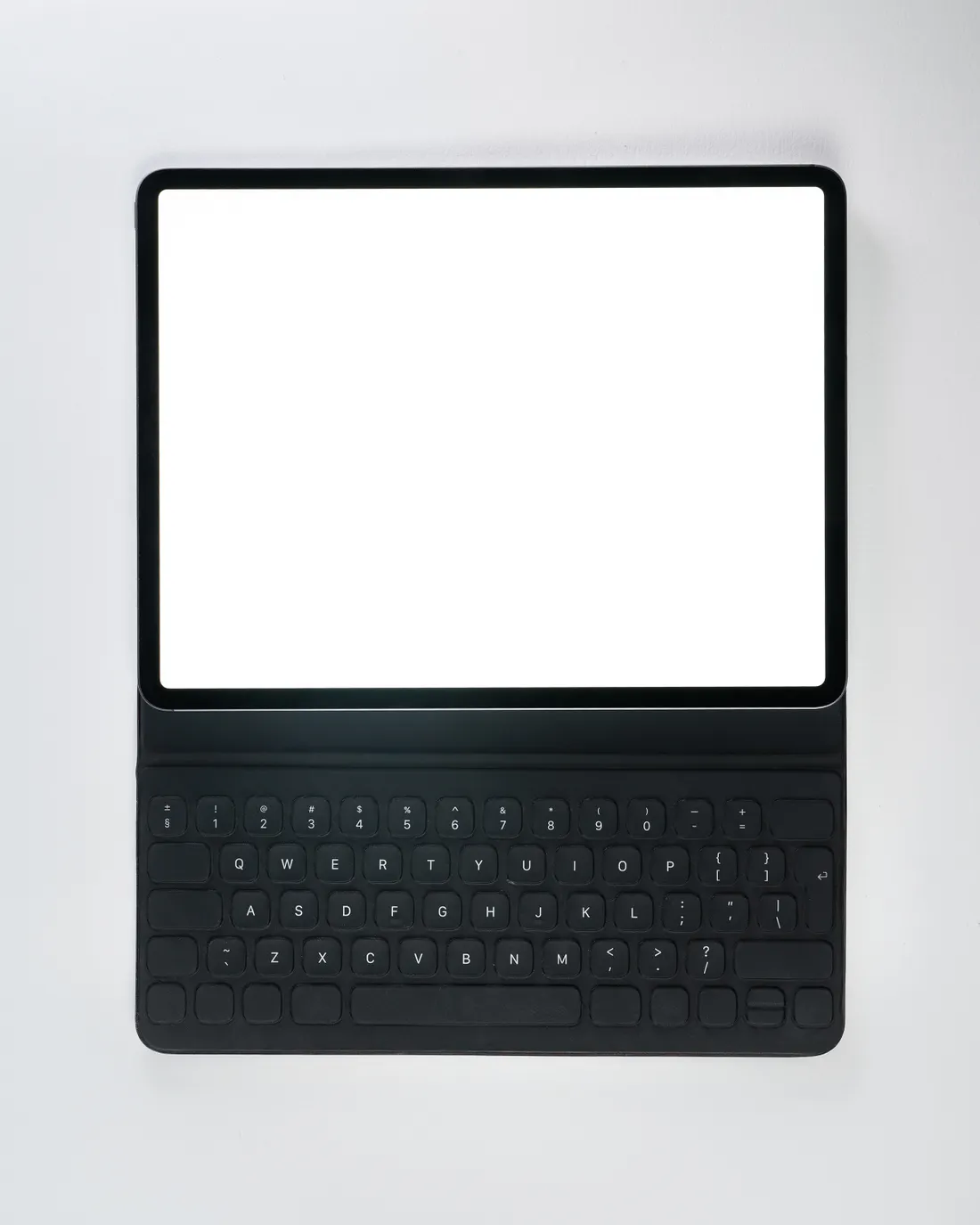 Tablet and detachable keyboard on a white work surface